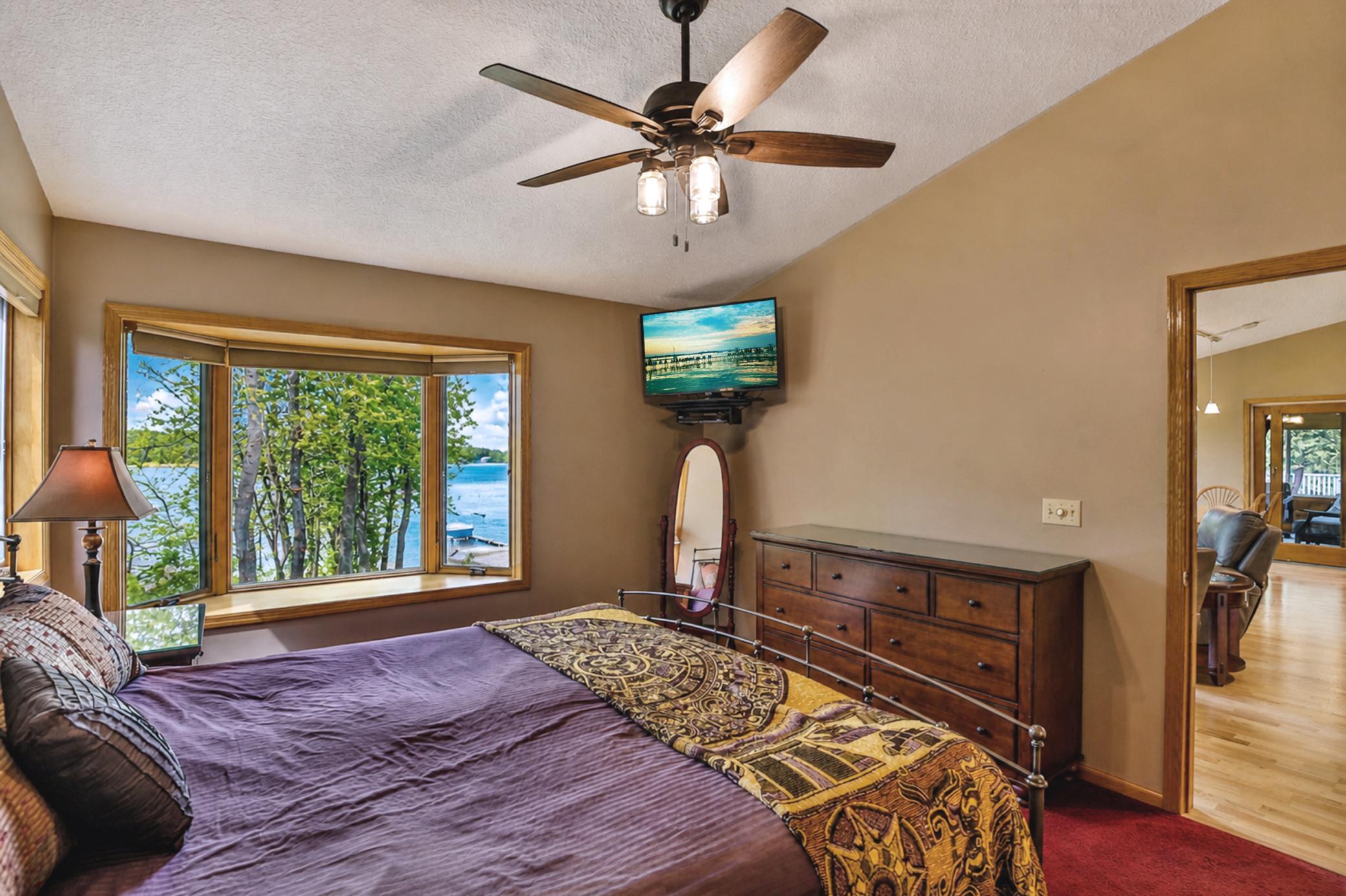 Primary bedroom with private view to the lake