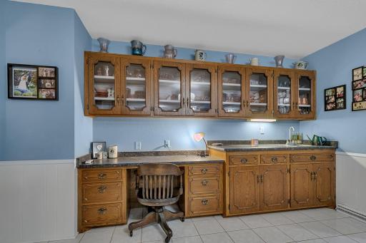 Work desk, wet bar and plenty of cabinet space here!
