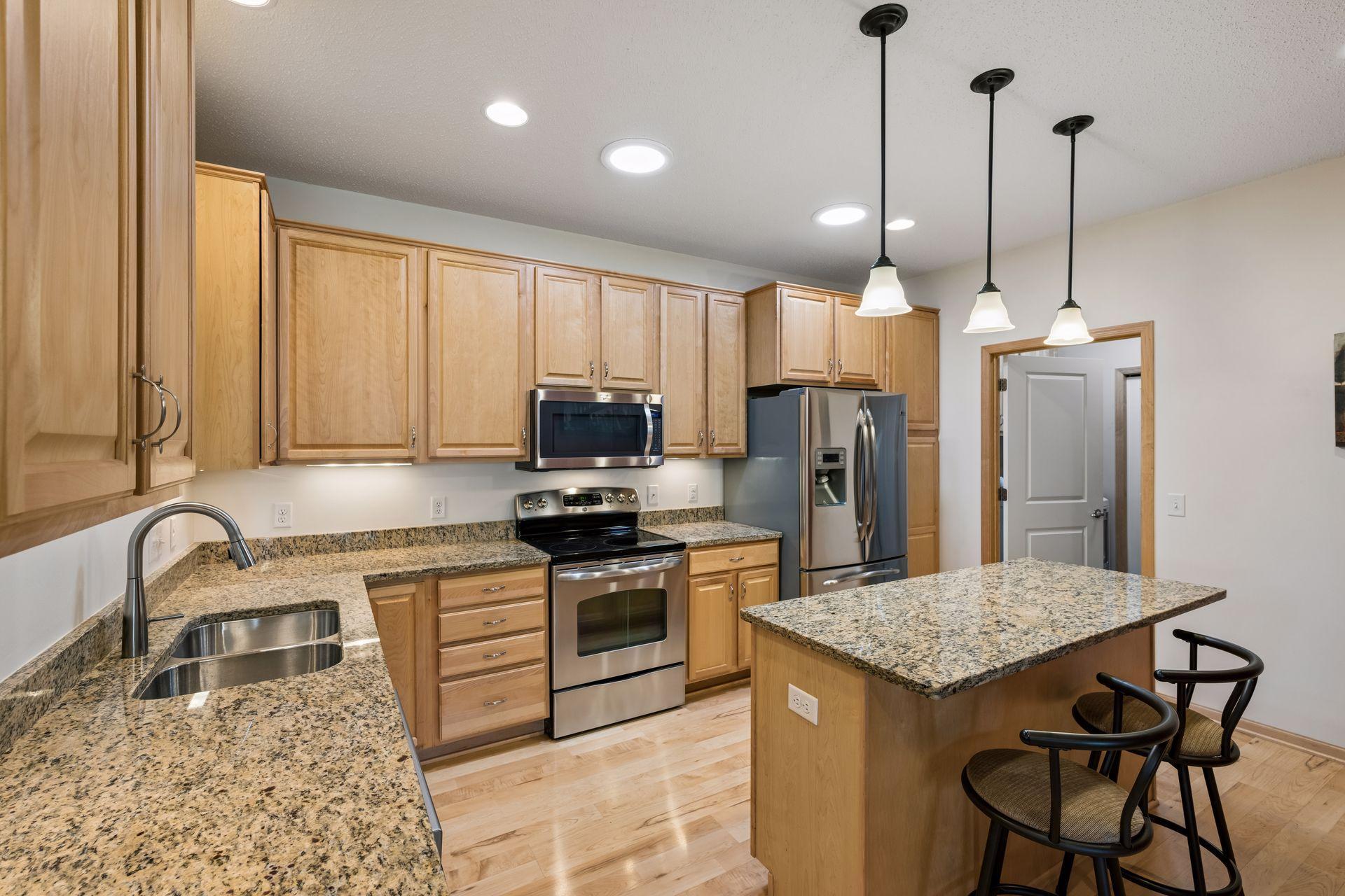 Spacious kitchen features an abundance of cabinetry, under-cabinet lighting, center island, and more!