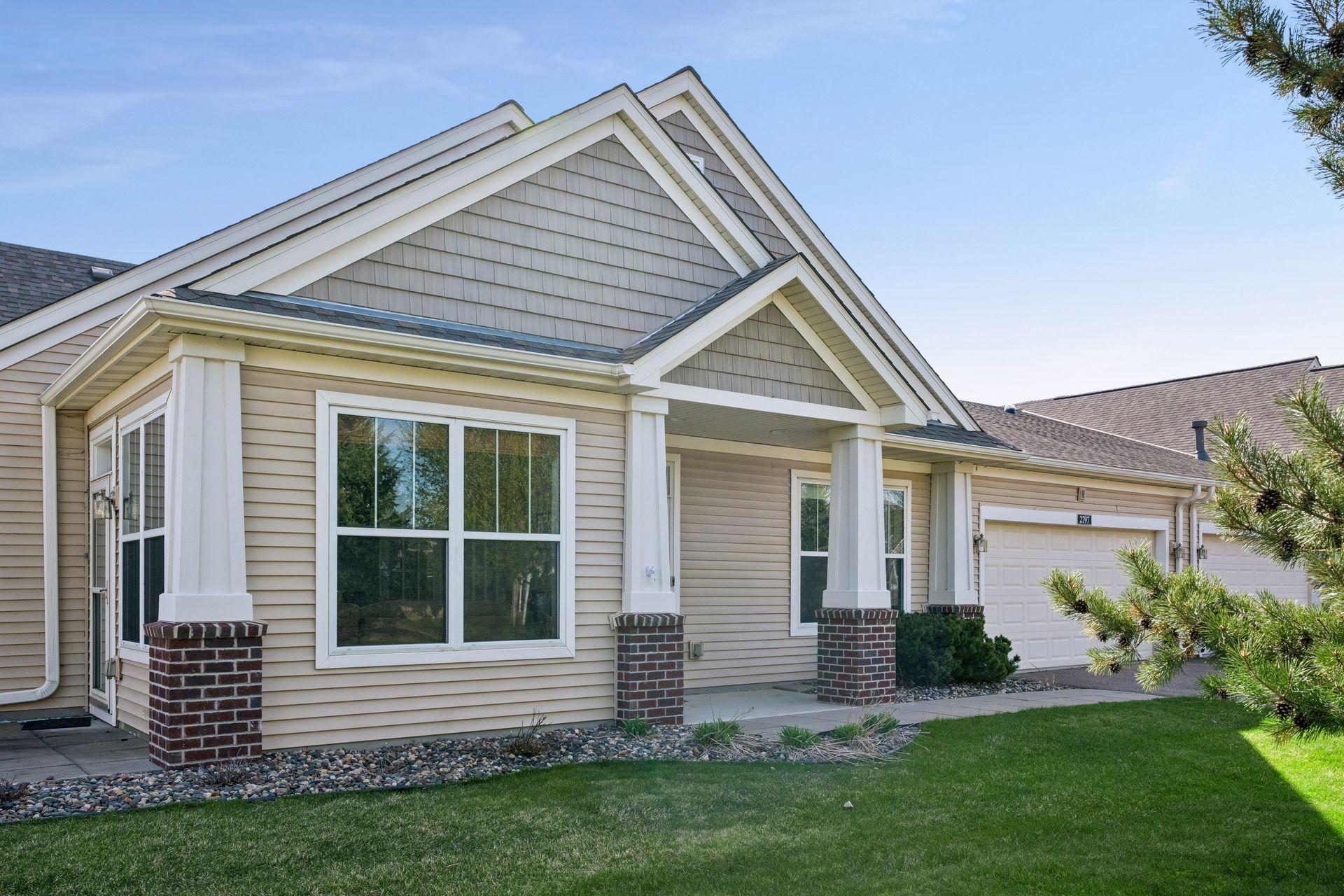 Quaint front porch offers space for seating, etc.
