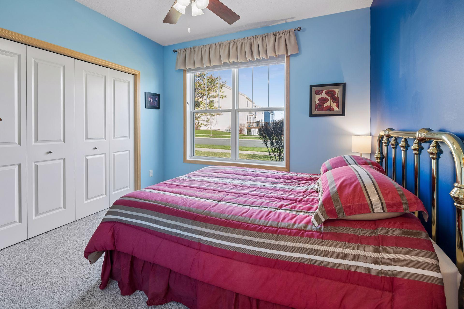 Second bedroom also features windows to the side of the home and a ceiling fan/light.