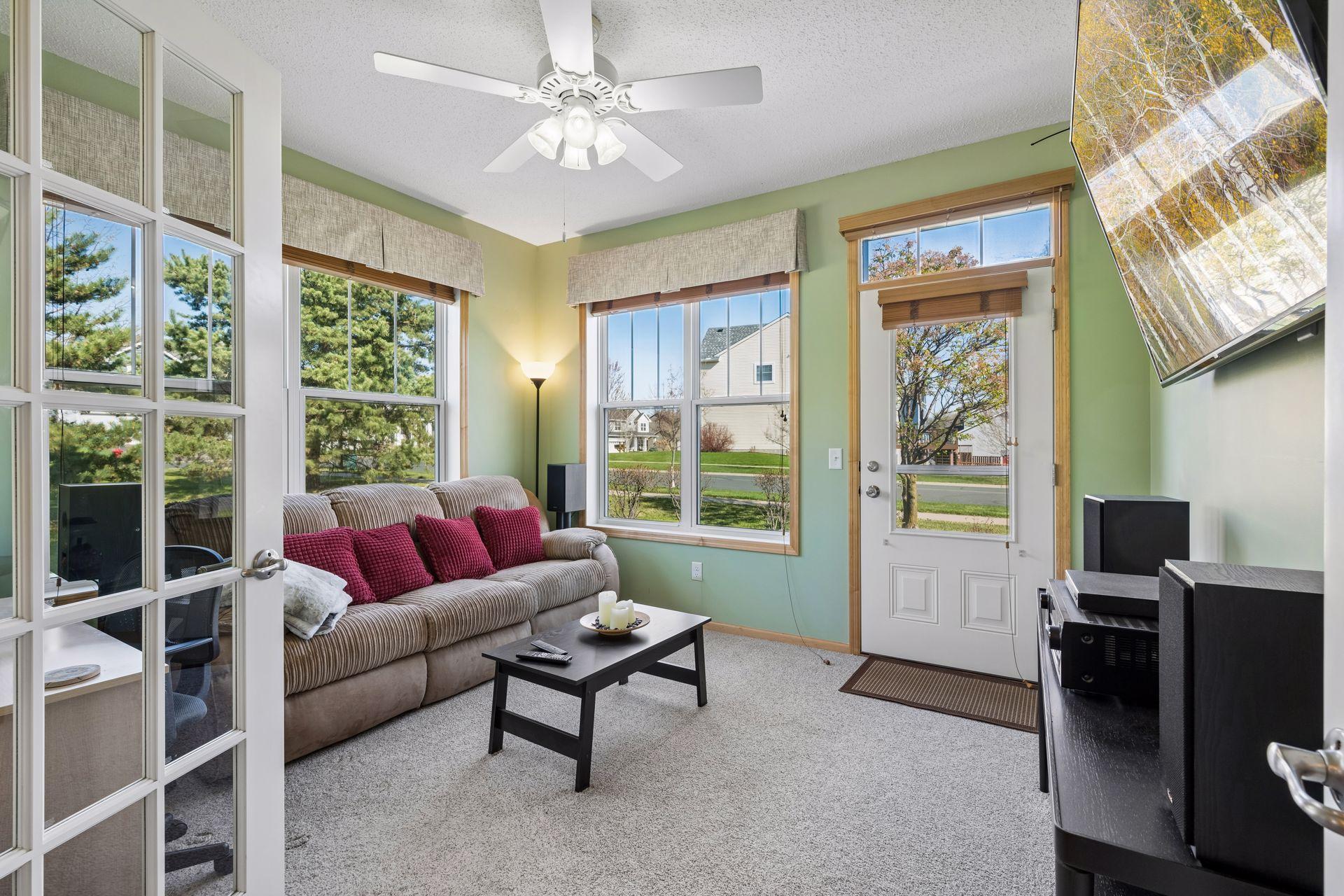 Opposite the living room is a fabulous den/sunroom filled with windows and a walkout to the side patio area.