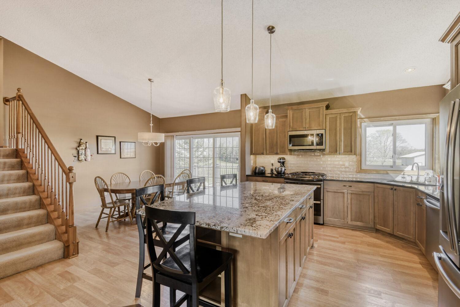 Open concept dining & kitchen. Large island with seating.