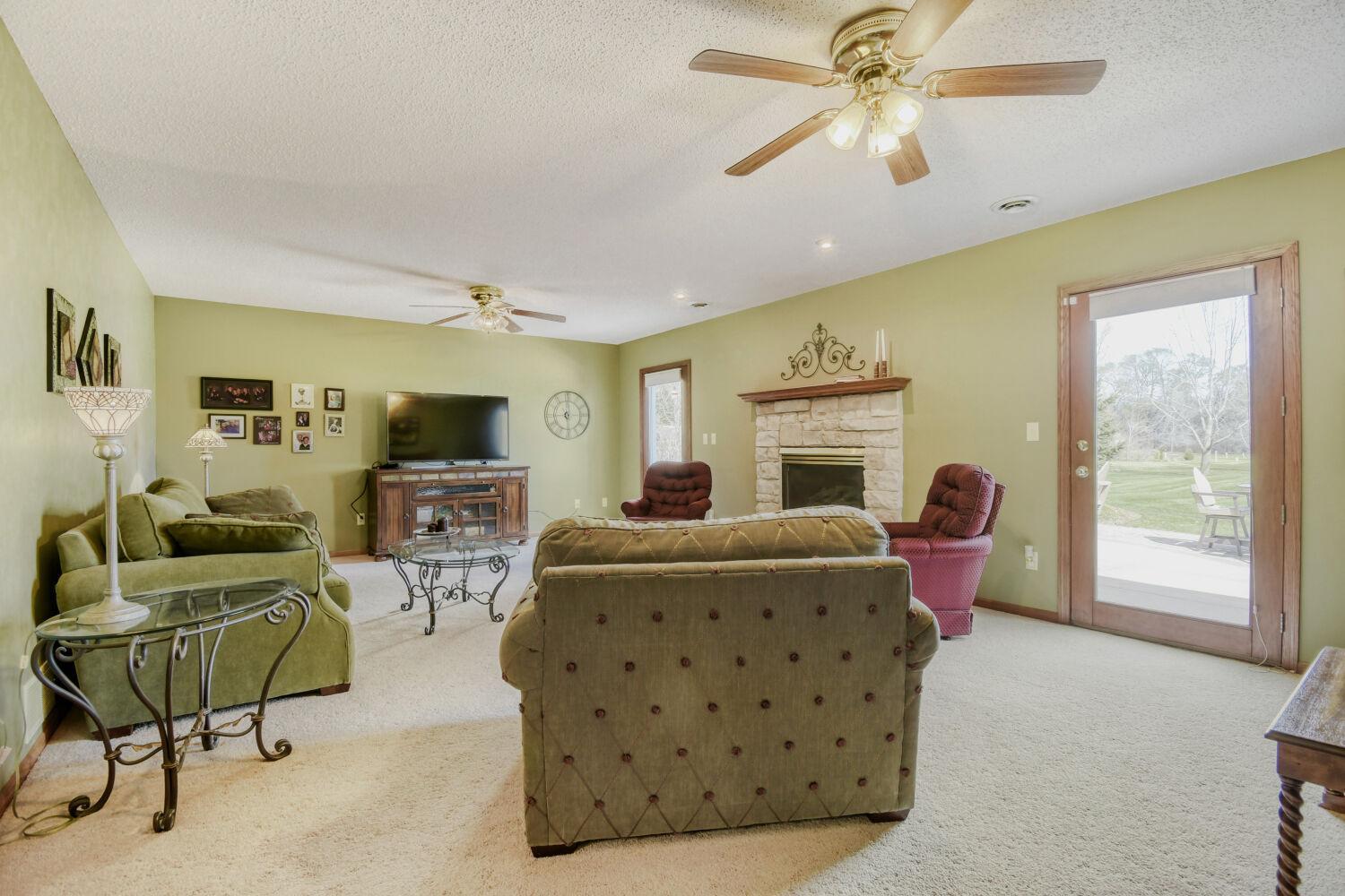 Family room with a gas fireplace and walkouts to the patio in the back yard.