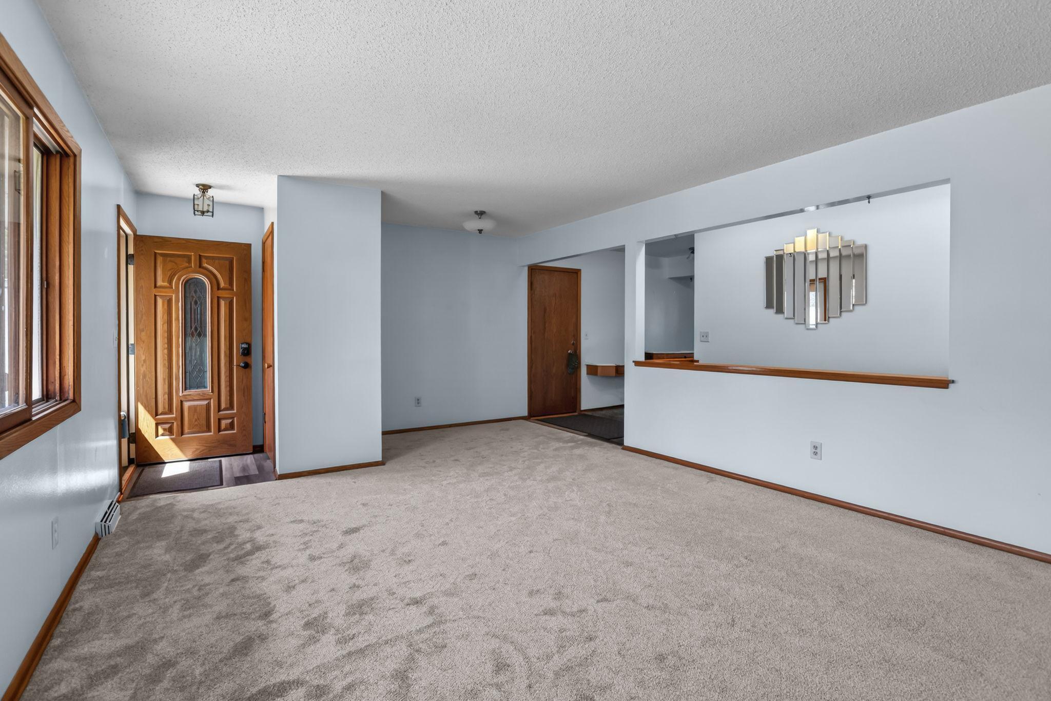 Another view of the living room & front door