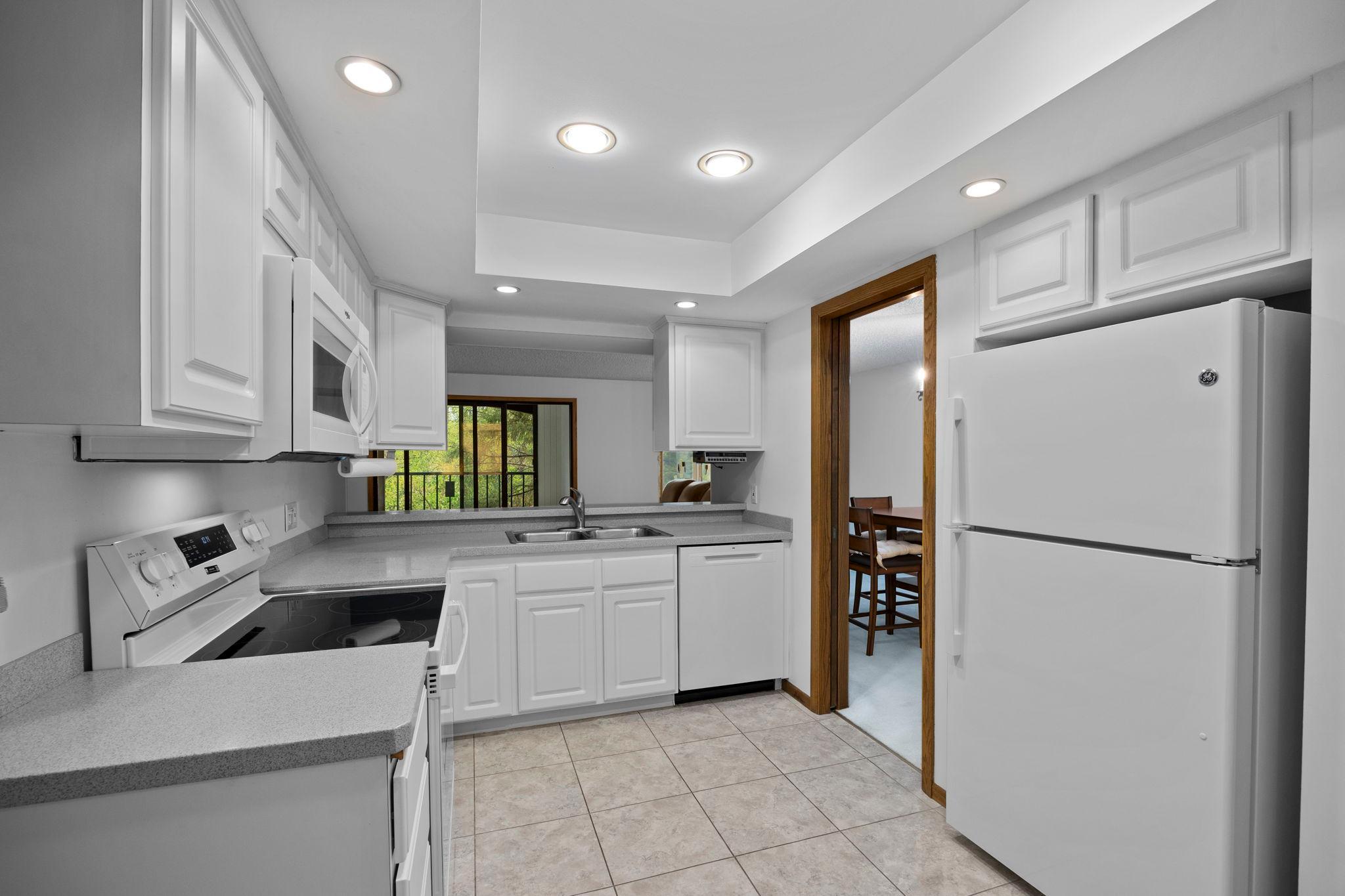 The living area flows seamlessly into the walk-through kitchen, designed for both function and connection.