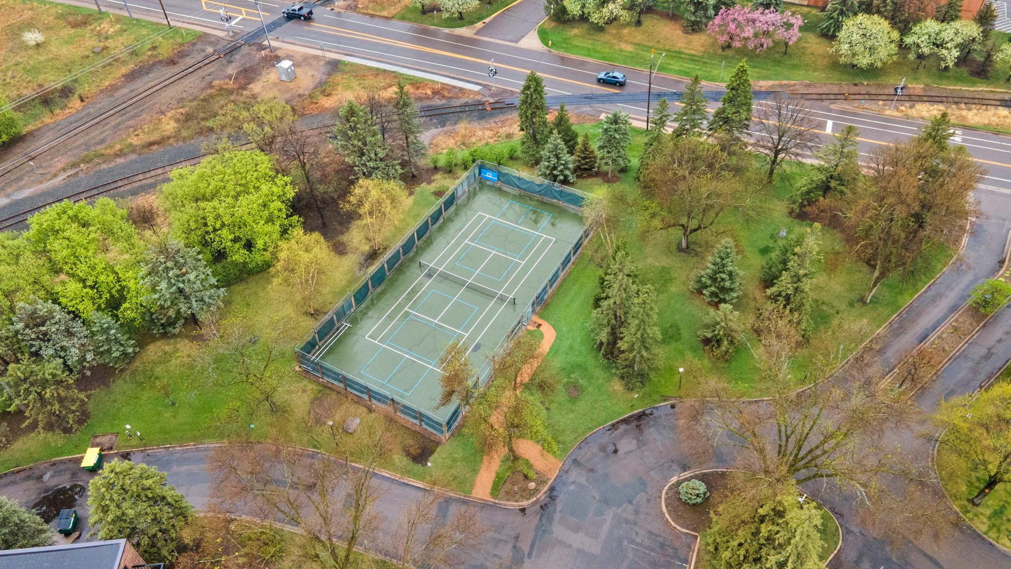 Outdoor recreation continues with private tennis and pickleball courts, along with guest parking.