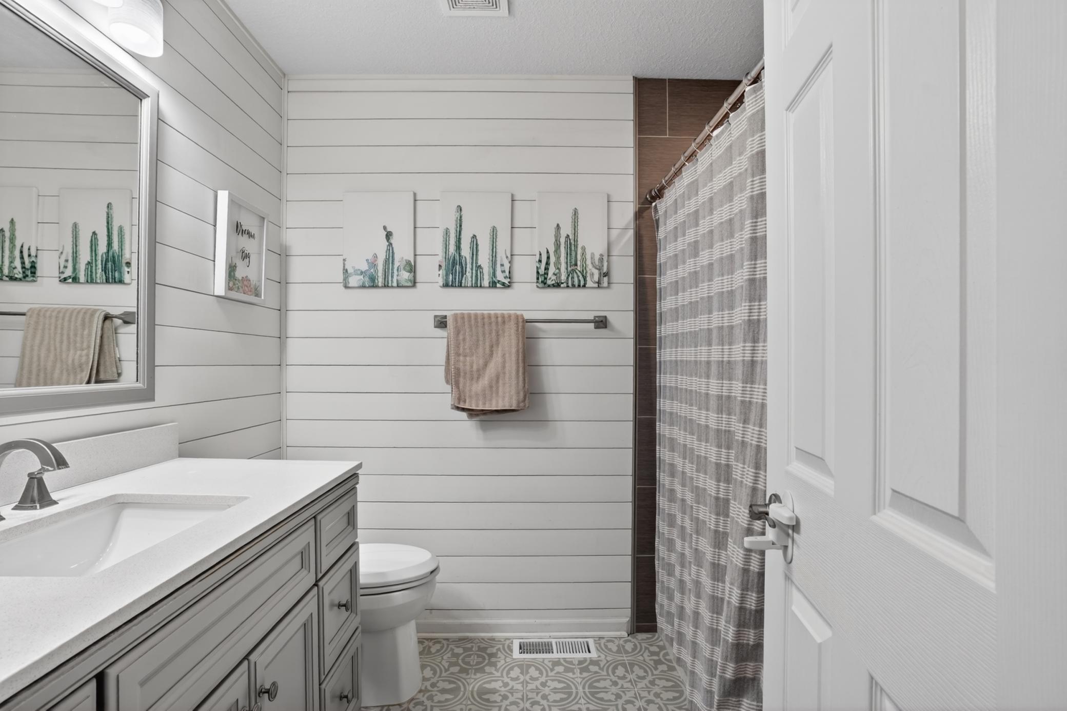 Upper level bath has really cute, high quality updates
