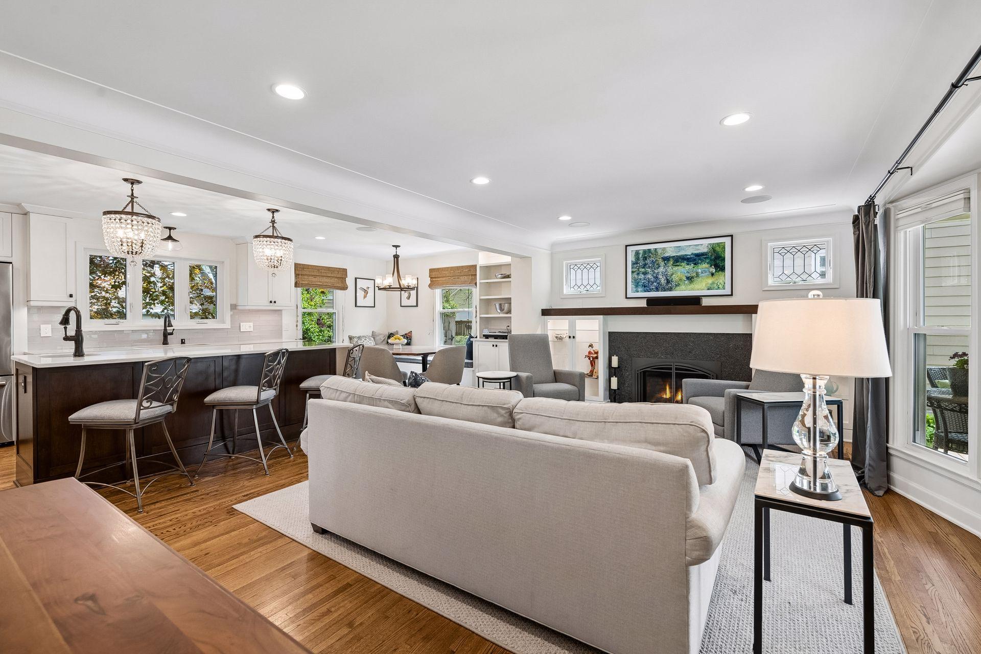 Inviting main floor with gleaming hardwood floors, updated lighting and layout, gas fireplace and updated windows.