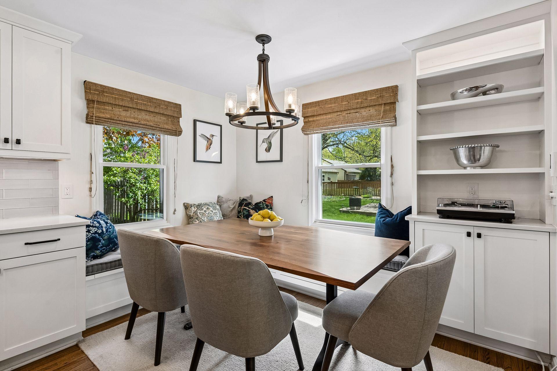 Dining nook with built-in custom bench seating and additional storage for display