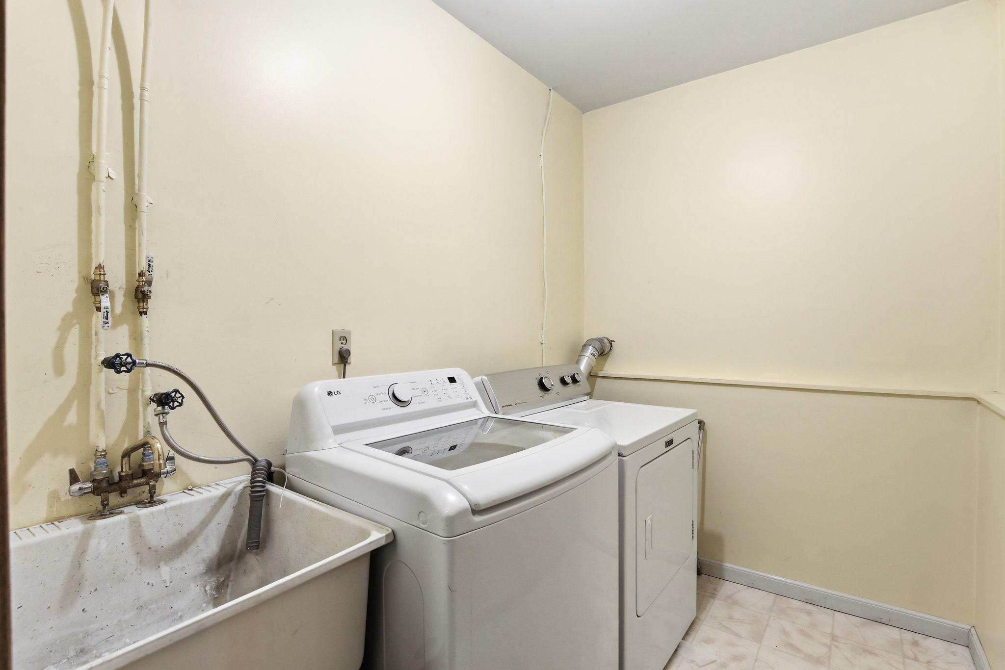 Dedicated lower-level laundry area offering a functional and convenient space for everyday chores, with ample room for washer and dryer setup and added organization.