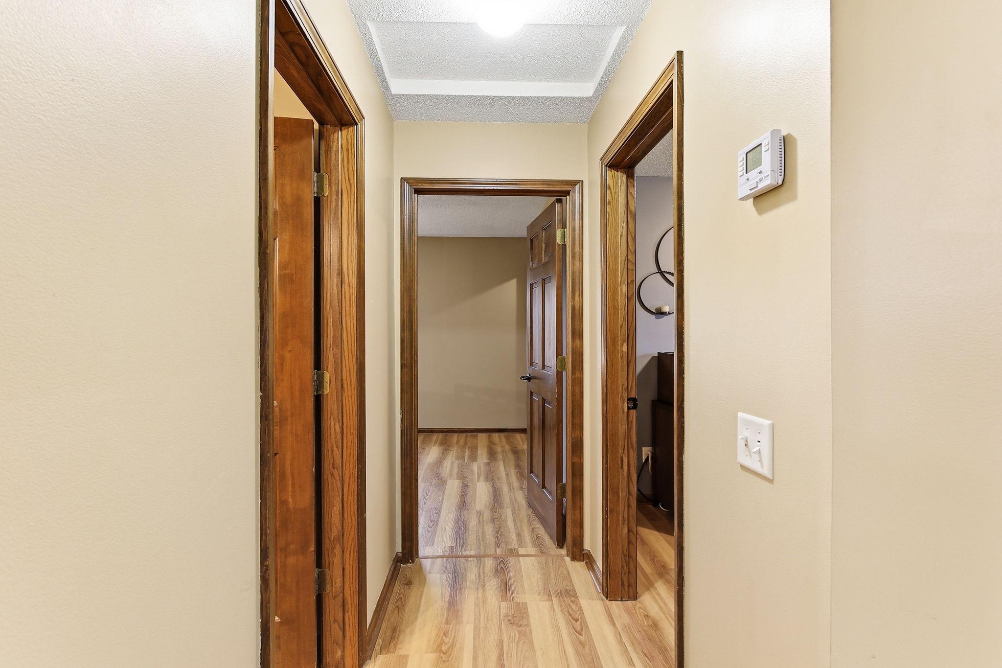 New Luxury Vinyl flooring (2026) in hallway, bedrooms and bath.
