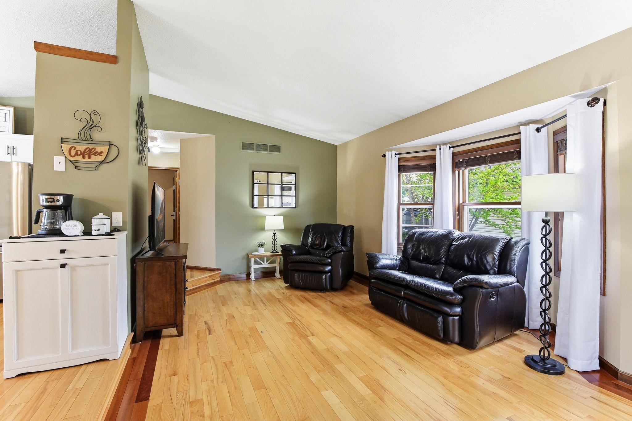 Hardwood flooring in living room, dining and kitchen offers a stylish, durable with a clean, modern look.