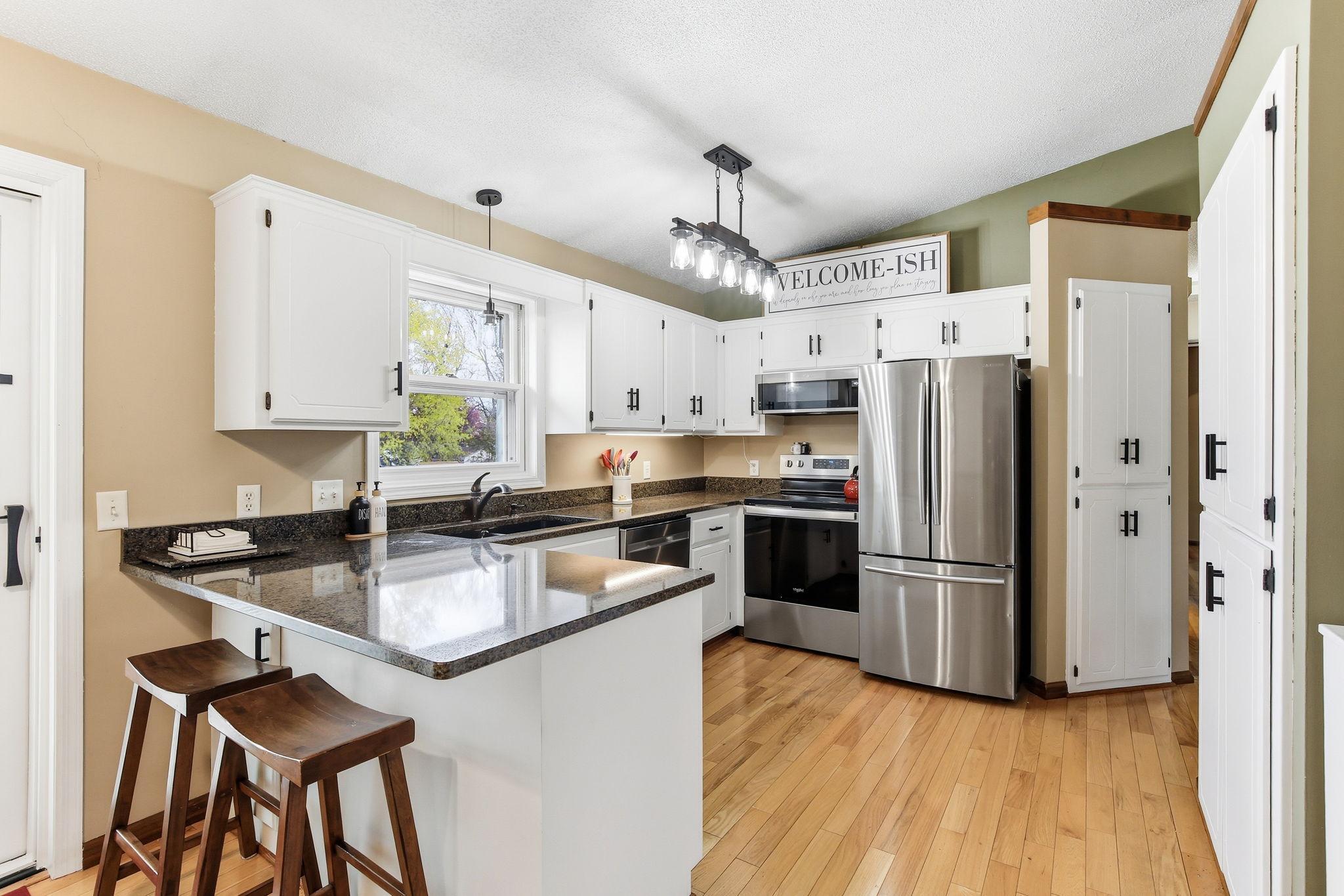 Newly painted white cabinets, Cambria Counter tops and SS appliances offer a fresh, clean look that brightens the space and enhances the kitchen’s modern appeal.
