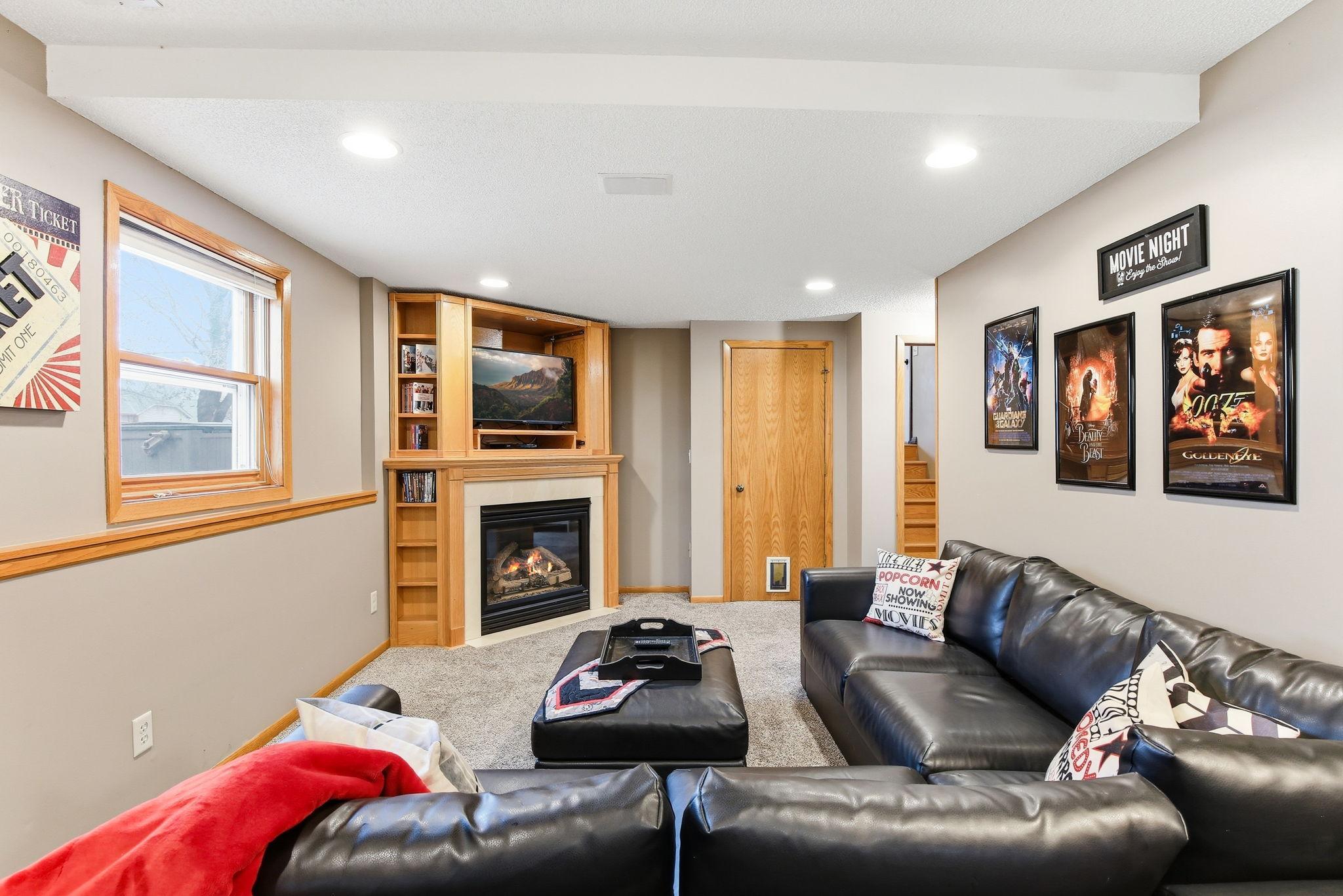 Gas fireplace with built-in surround storage creates a warm and inviting focal point, combining cozy ambiance with practical built-in cabinetry for convenient and stylish storage.