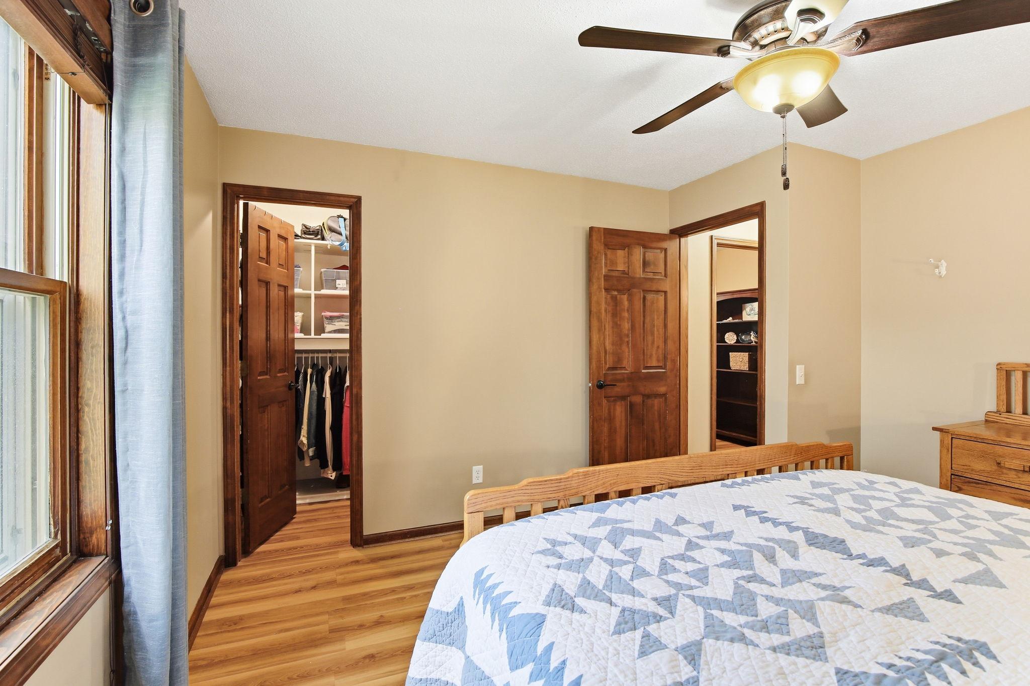 Must-see primary closet featuring a thoughtfully designed layout with ample hanging space and built-in storage, offering exceptional organization and a clean, streamlined look.