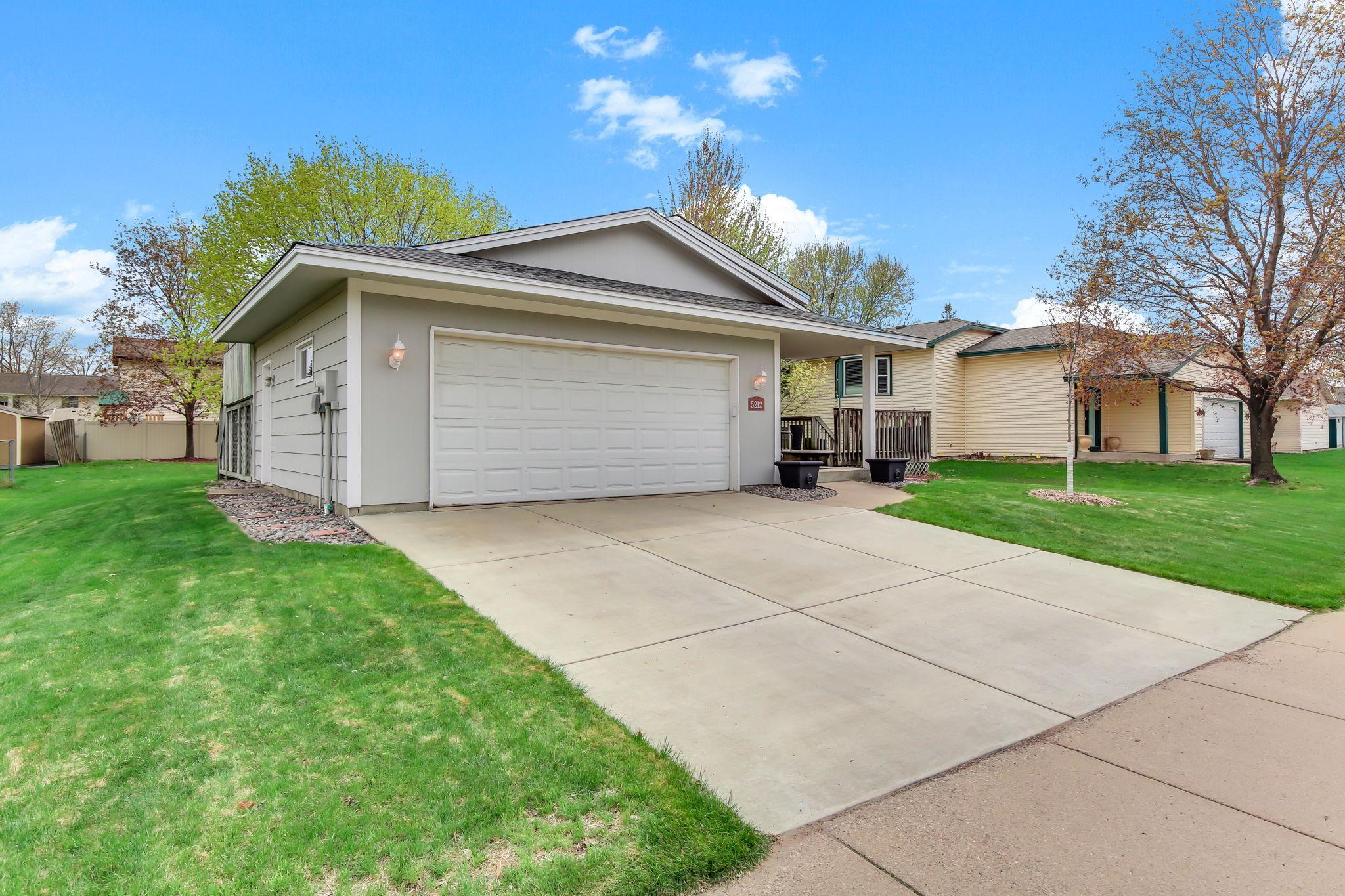 Well-maintained concrete driveway (2015) offering a clean, durable, and low-maintenance approach to the home, providing ample space for parking and smooth access year-round.