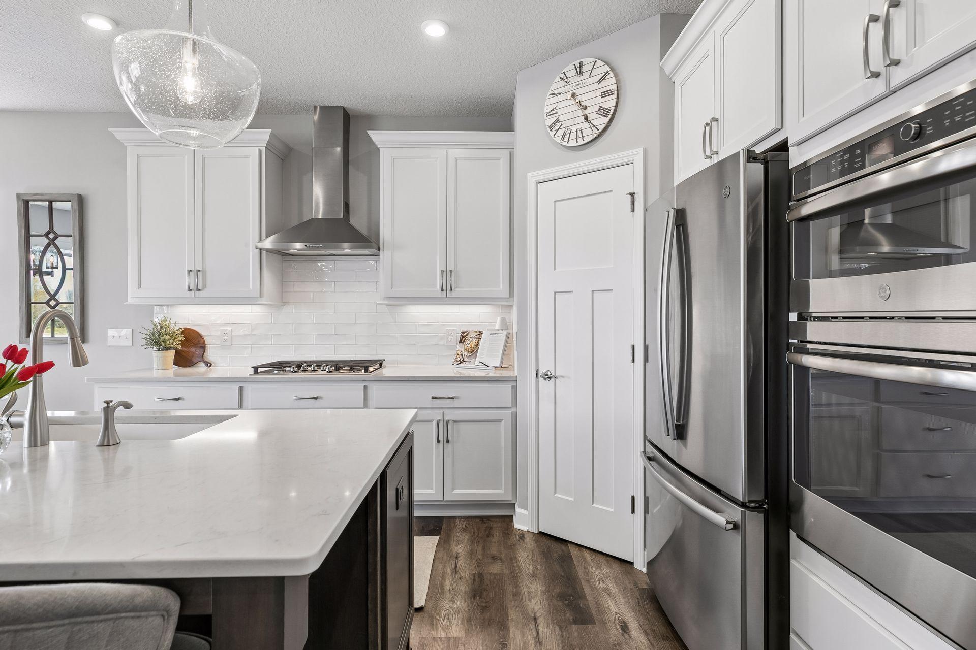 Upgraded GE Profile Appliances. Built-in Oven with Convention Microwave above - which acts as a second oven. Sleek high capacity vent over the gas range was upgraded as well. Walk-in pantry with full adjustable shelves and roll outs.