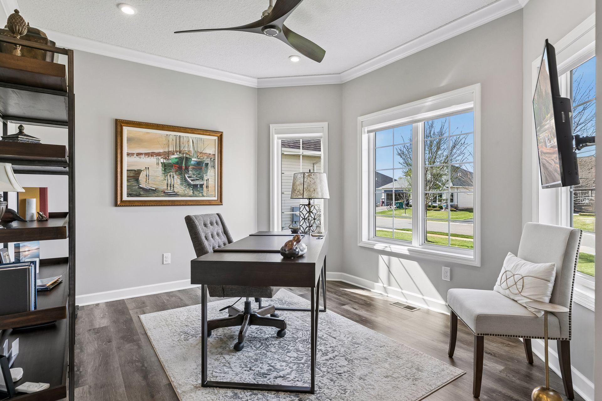 Front den or office - highlighted by crown molding, custom blinds (which you will find throughout the home) and wall mounted TV.