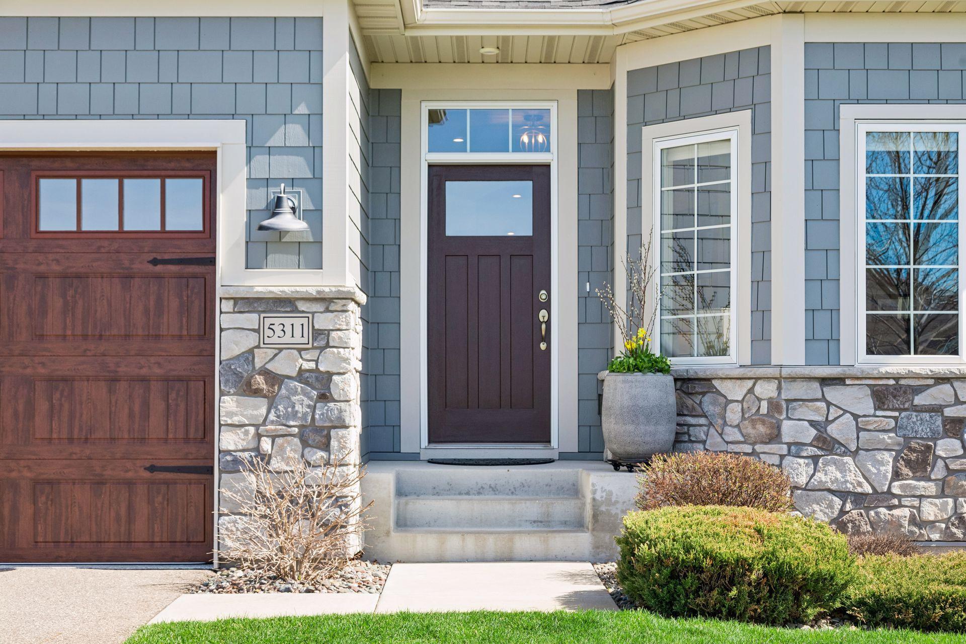 Impressive first impression - upgraded 8ft high wood grain garage door, James Hardi shakes with board and batten vertical siding, along with recently refinished front door and upgraded high quality and durable vinyl siding.