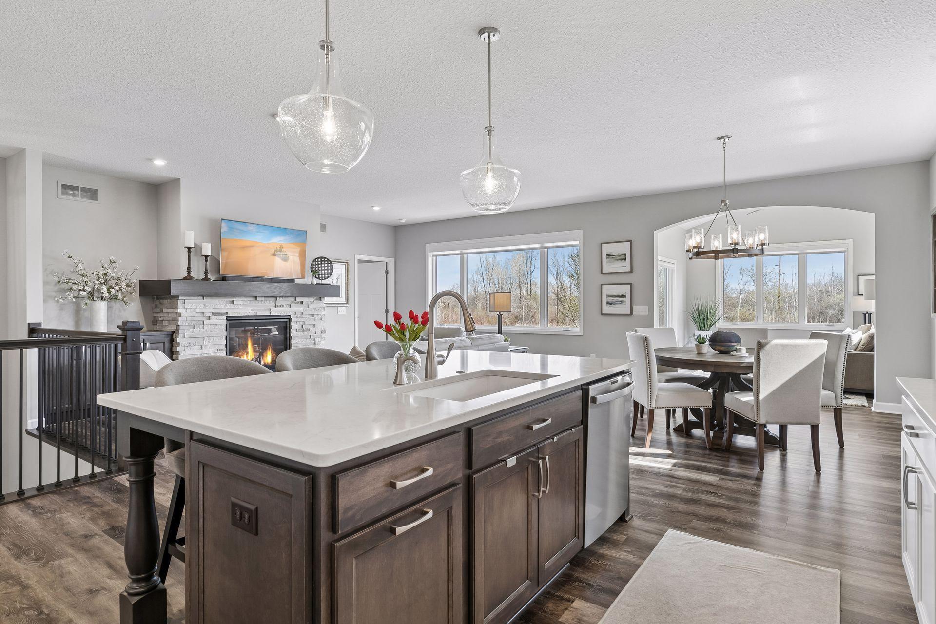 Who would mind doing dishes with a view like this! Sink is upgraded quartz as well. Trash/recycling roll out to the left of sink.