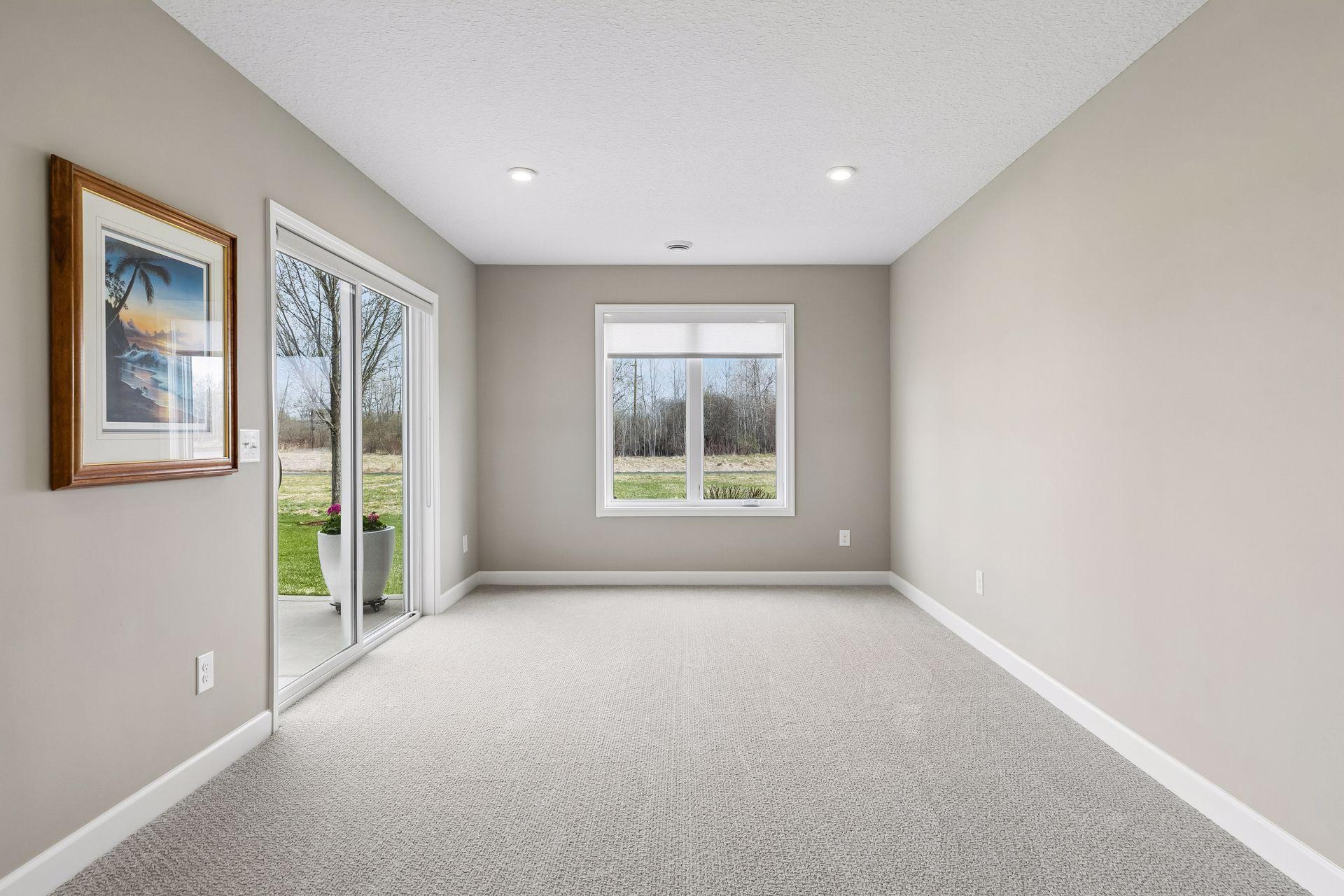This is the room under the upper level sun room. Makes for another great sitting room or game table. With sliding door leading to patio.