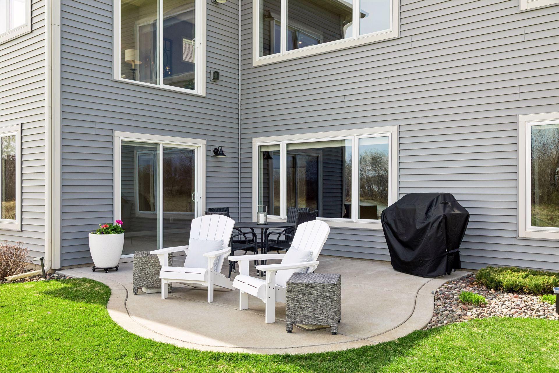The concrete patio has a gentle curved edge that softens the space and transitions nicely into the surrounding meticulously maintained yard. The patio also has footing in preparation for you to add a future 16x12 deck above.