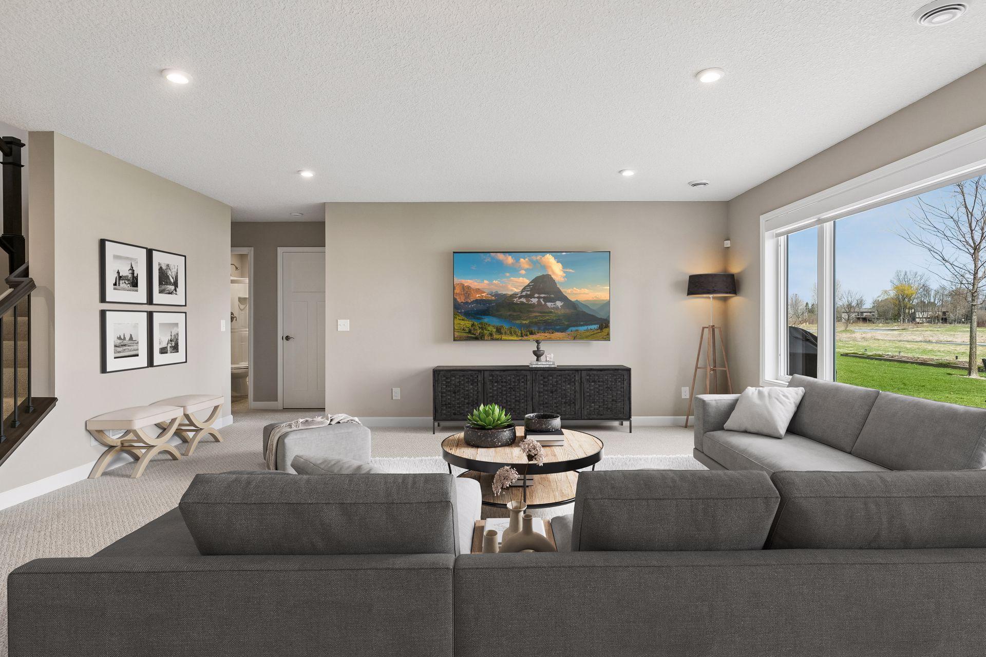 The large windows bring the inside in. Custom blinds/shades on all the windows for privacy and light control. (Virtual staged in this photo)