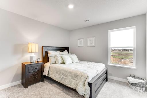 One of four, large, secondary bedrooms on the upper level. *Photo is of a model home.