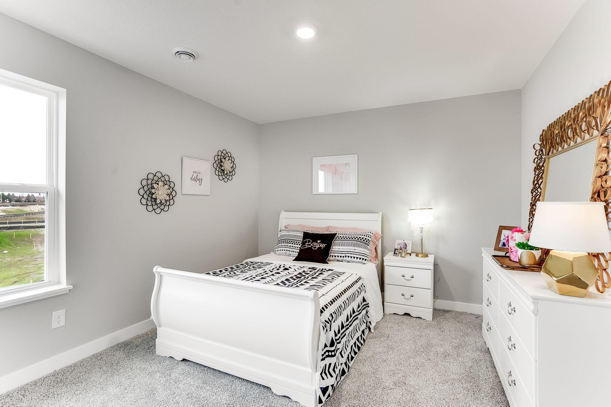 One of three, large, secondary bedrooms on the upper level. *Photo is of a model home