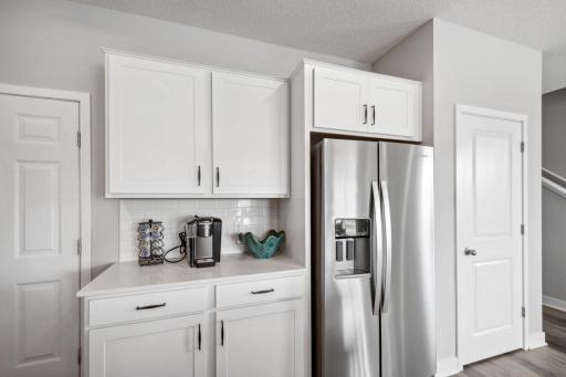 Beautiful quartz countertops and delicate white backsplash! *Photo is of a model home.