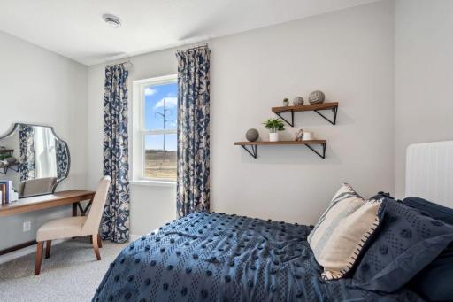 This main level bedroom could be used as an office, den, playroom, spare bedroom, workout room, den! *Photo is of a model home.