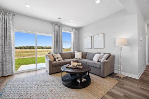 Great light and plenty of space in this living room! *Photo is of a model home.
