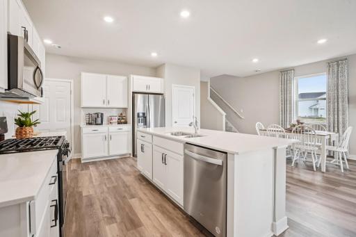 Fantastic kitchen boasting a huge island, gas stove, microwave hood vented to the exterior and a pantry! *Photo is of a model home.