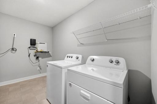 Upper level laundry room. *Photo is of a model home.