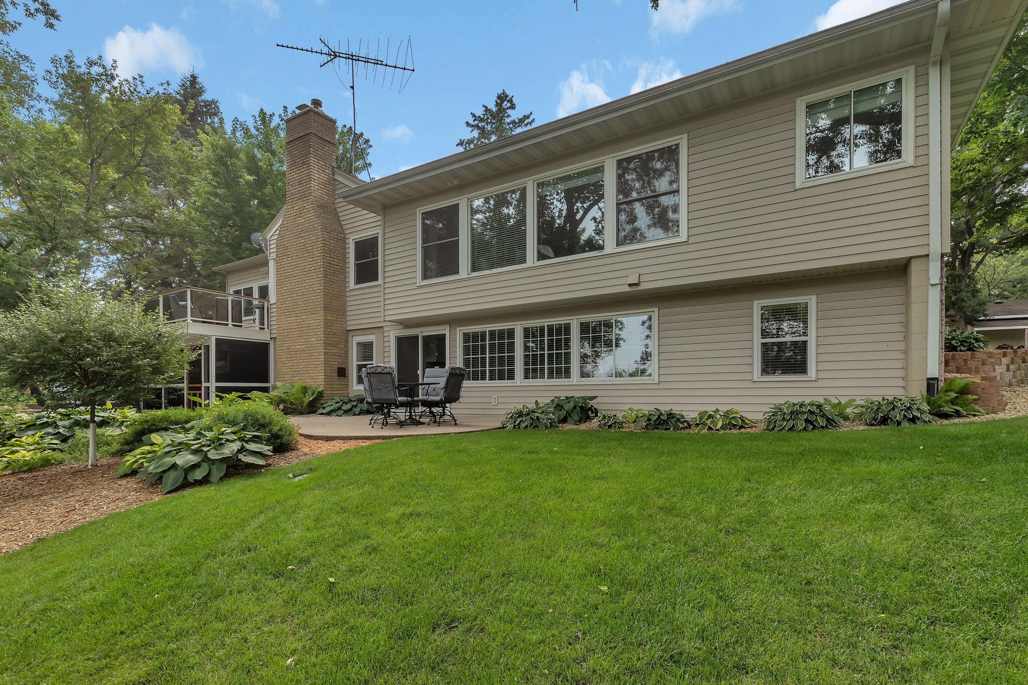 Two Patio Areas With Connecting Sidewalk And Deck Perched Up High Giving Way To Dramatic Views Of The Wooded Lot Behind And Winks Of The River!!!