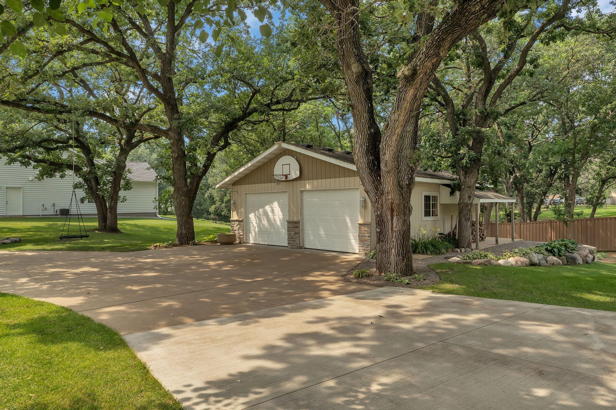 Wow WHAT A SETTING! Very Spacious DETACHED GARAGE Complete With Side Porch And Wrap Around Cemented Area.