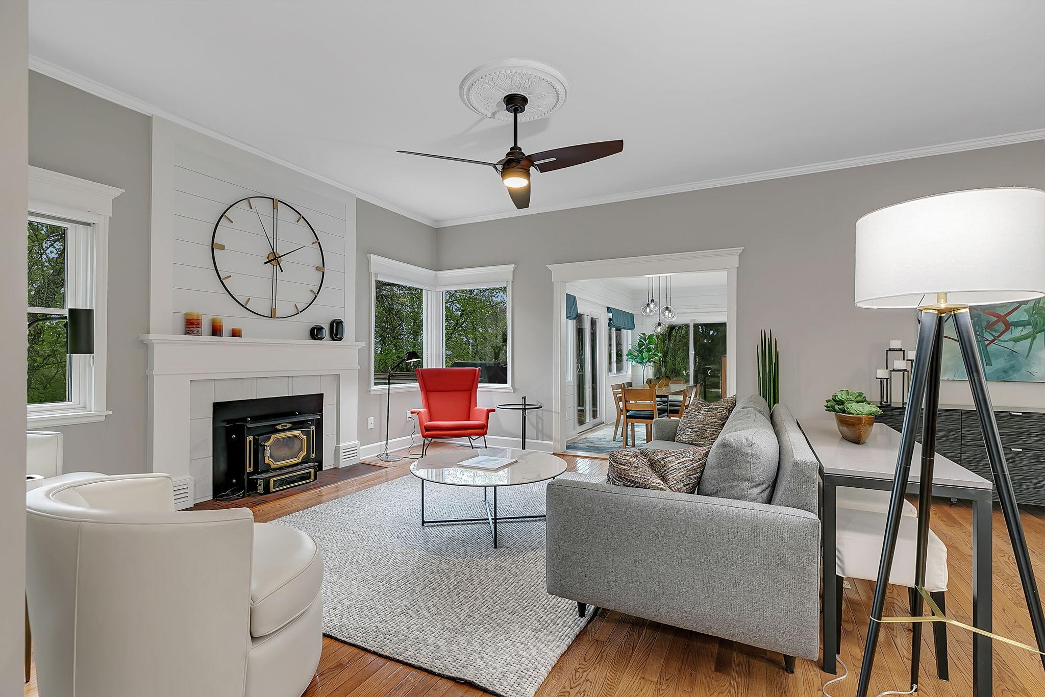 Sun-drenched and spacious, the main floor living area boasts a fresh, modern design and picturesque views overlooking the mature trees and expansive green lawn!