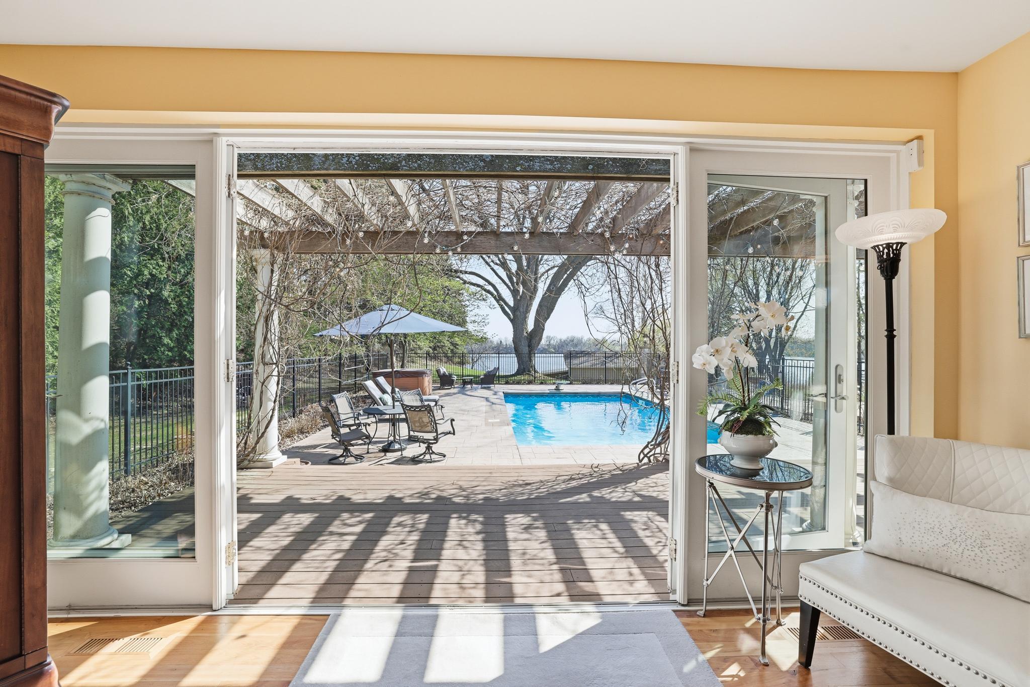 Primary suite doors open to deck and pool