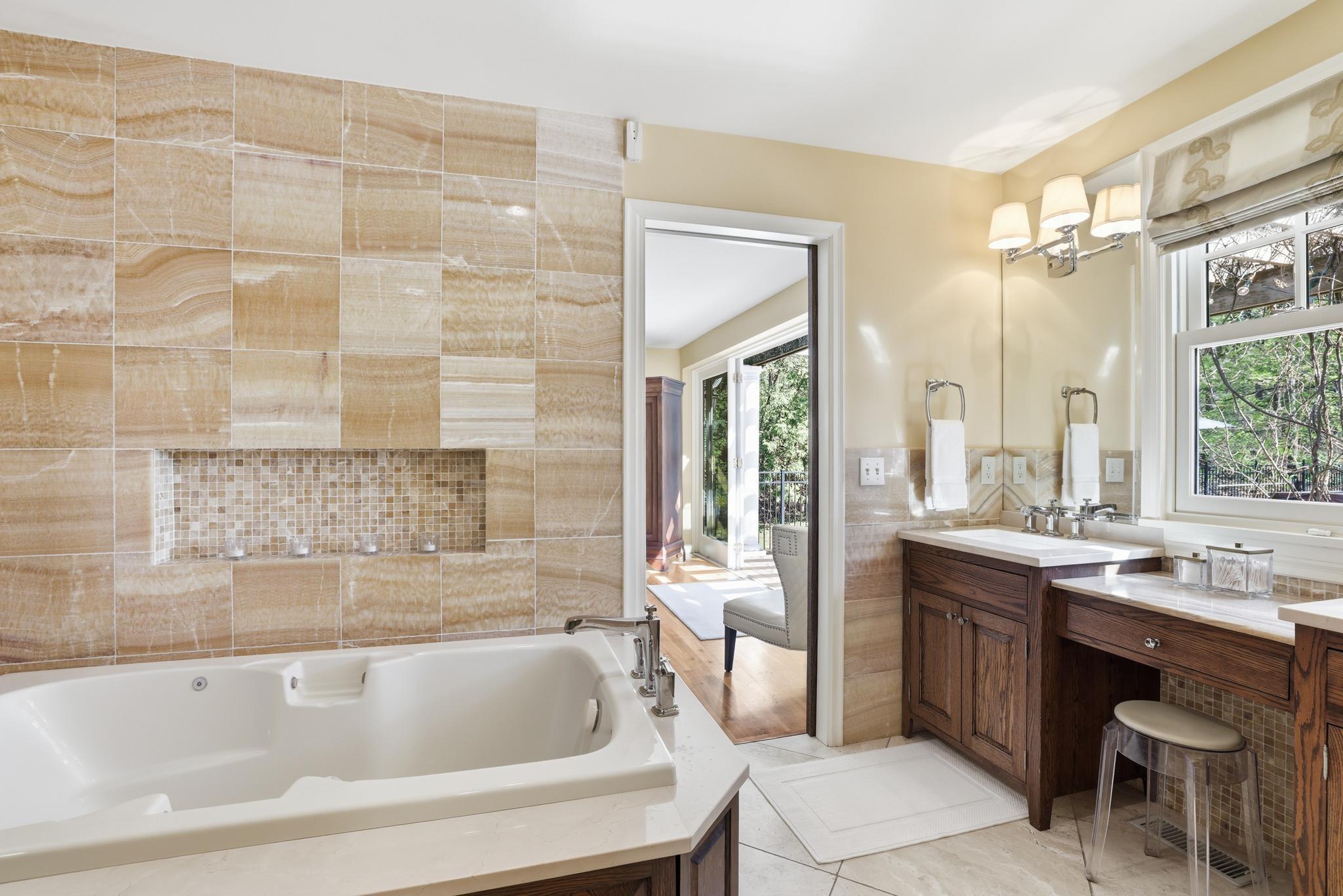 Primary bath with separate tub and shower. Heated floor and dual sinks.