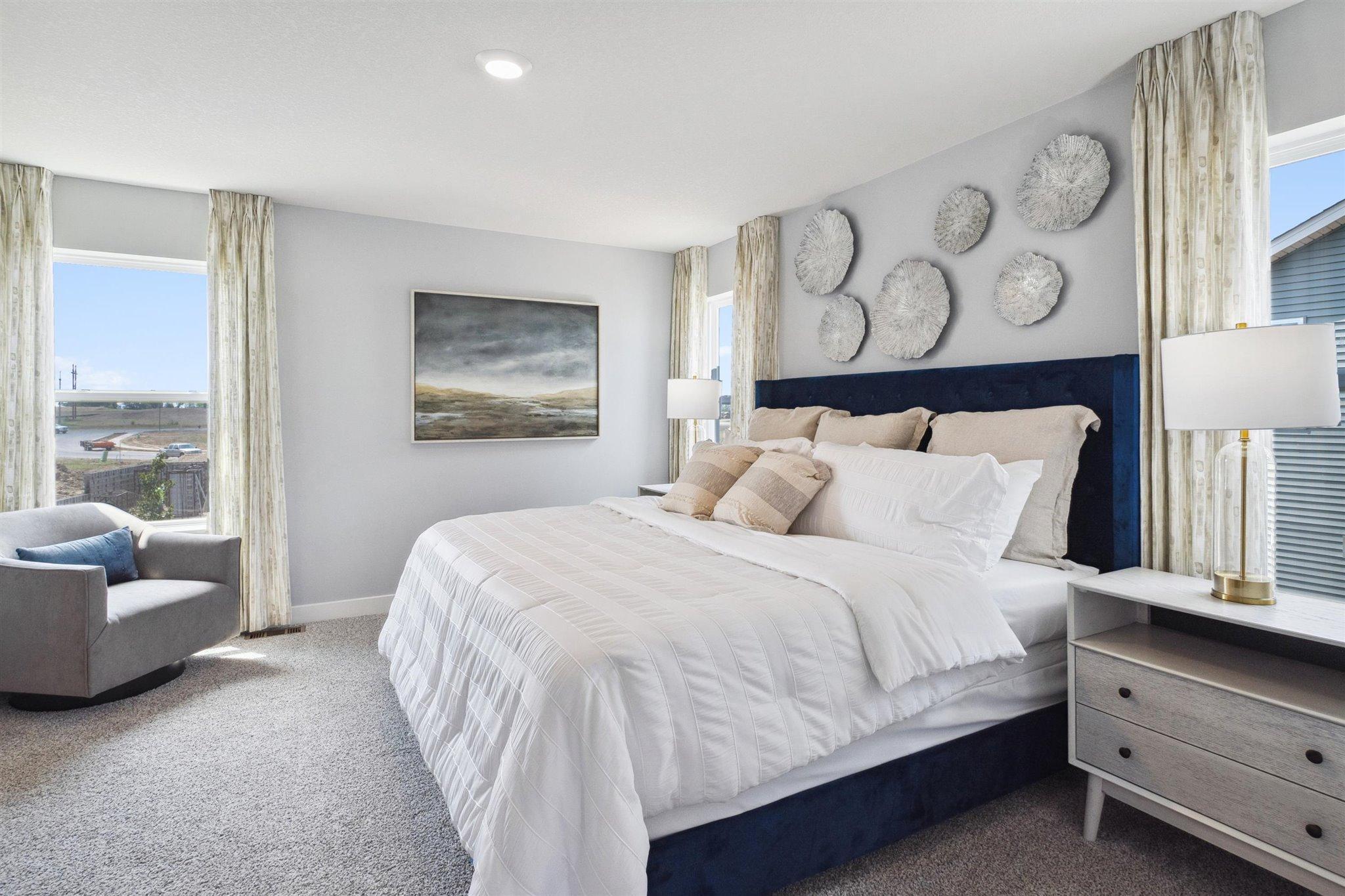 The primary ensuite is large! Pictured with a king size bed, there is still ample room for a sitting area and additional furniture!