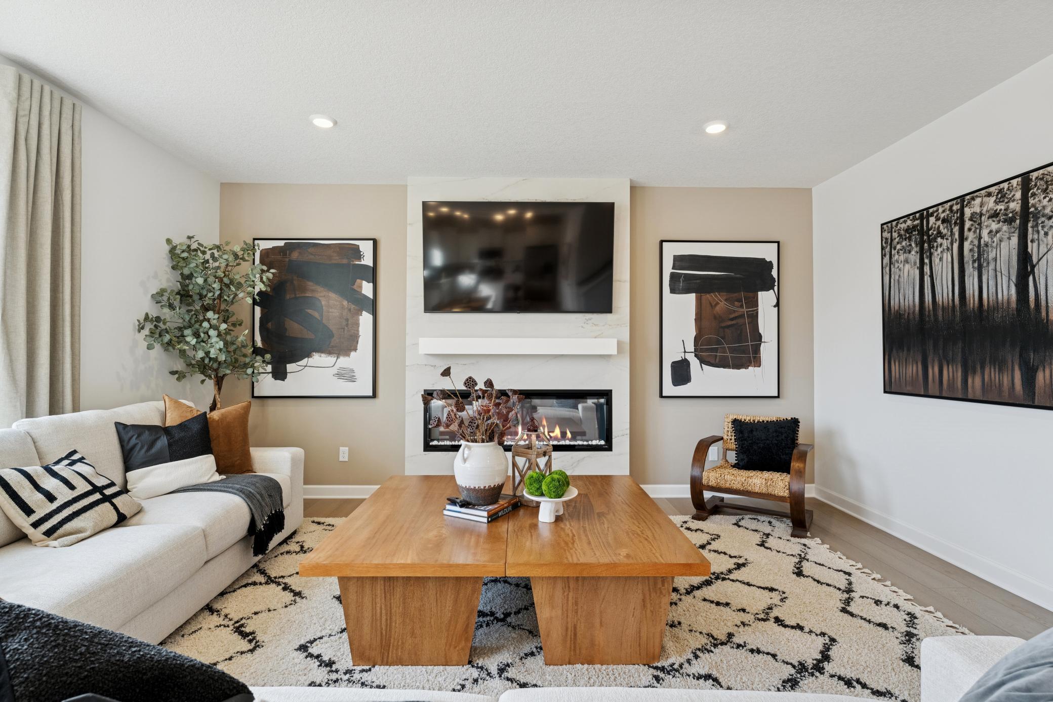 (*Photo of actual model) The cozy Great Room has an electric fireplace as a stunning accent to the space