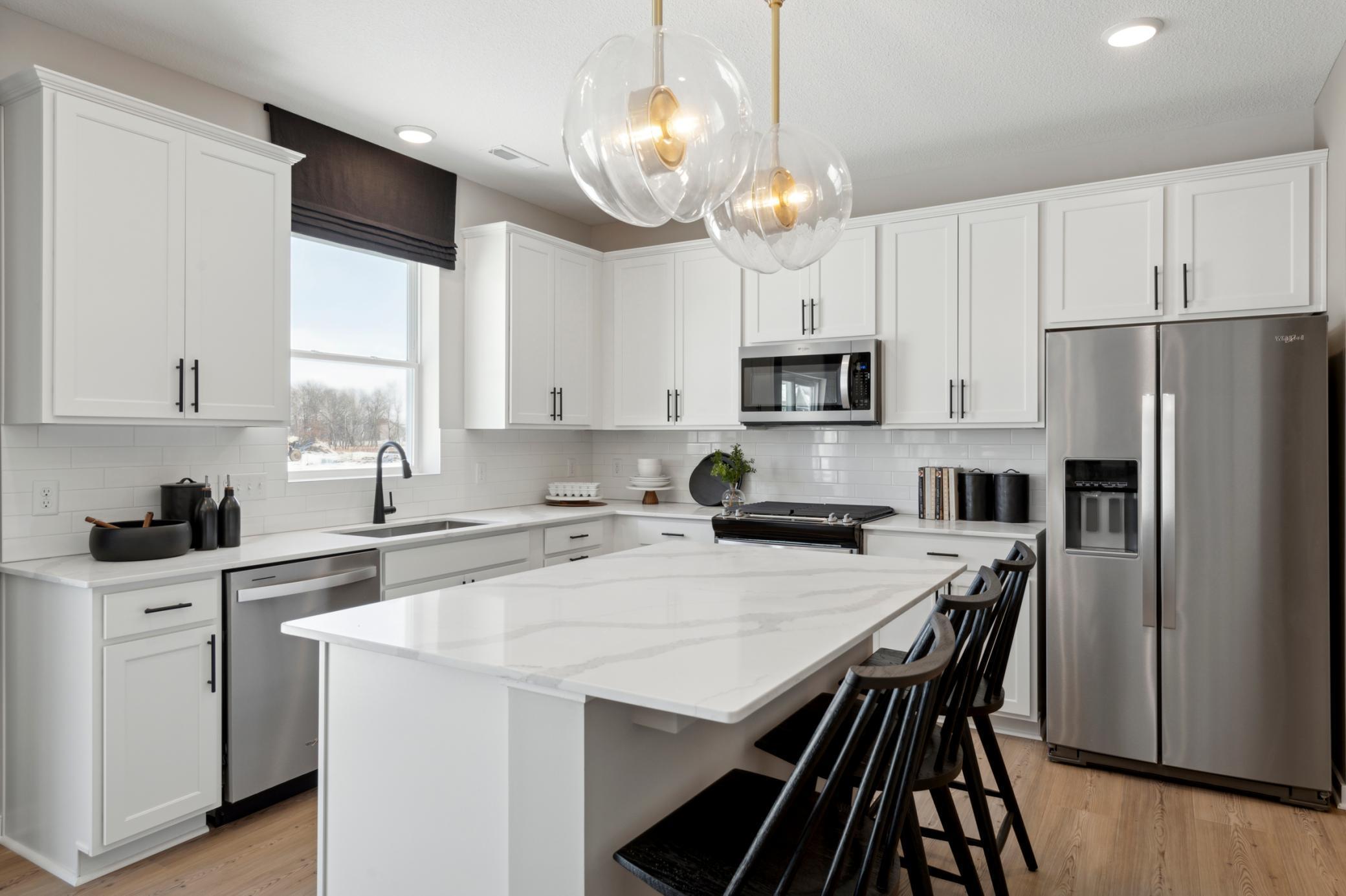 Expansive island with quartz surface offers additional prep space, bar seating, and a stylish centerpiece to your new kitchen..jpg