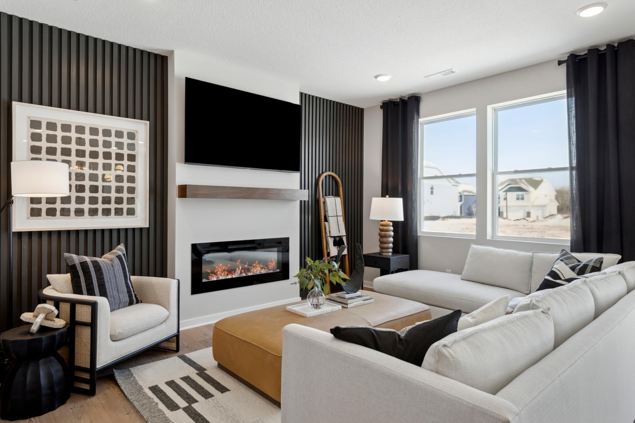 Spacious family room at the heart of the home, featuring soaring 9-foot ceilings and a cozy fireplace that adds warmth and charm..jpg