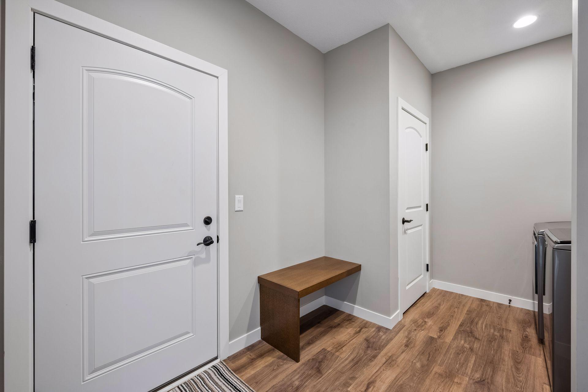 Entrance from the garage with a large closet and laundry.