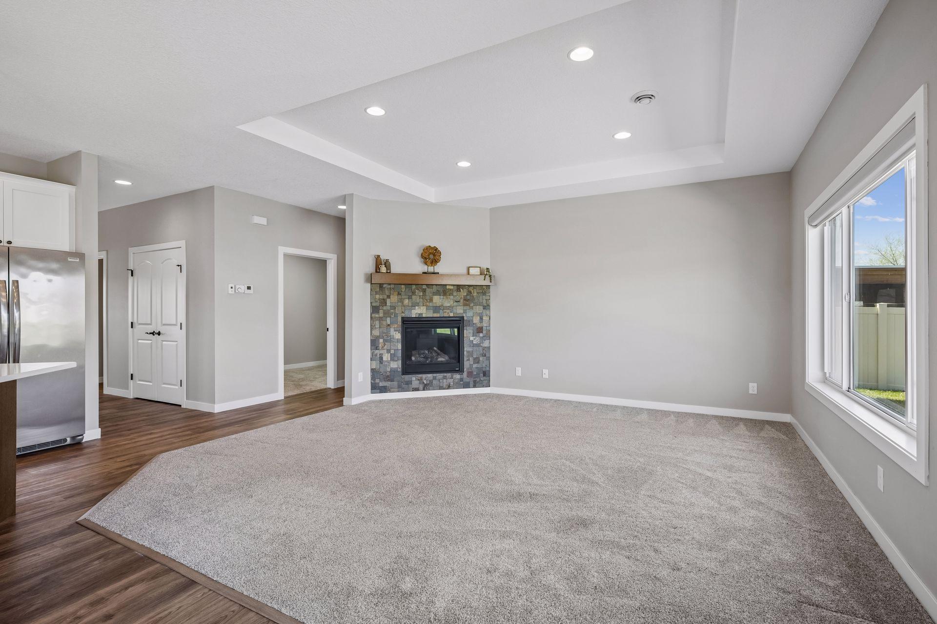 Open-concept design with high-end finishes. Bright living room with upgraded fireplace with slate surround and wood mantel.