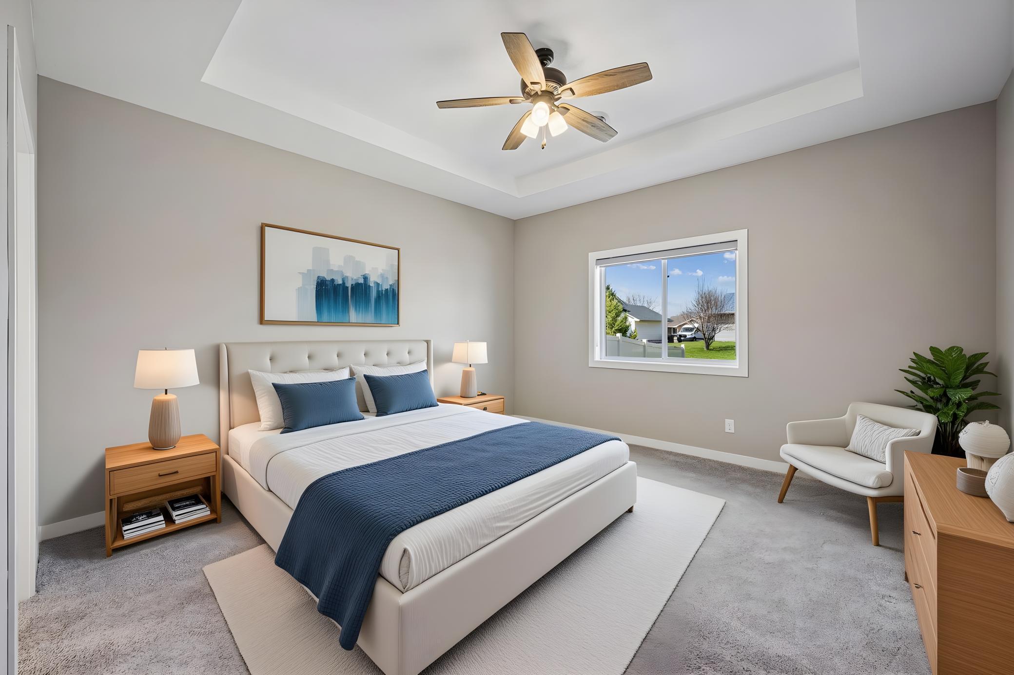 Virtually staged primary bedrooms with tray ceiling and an electric shade.