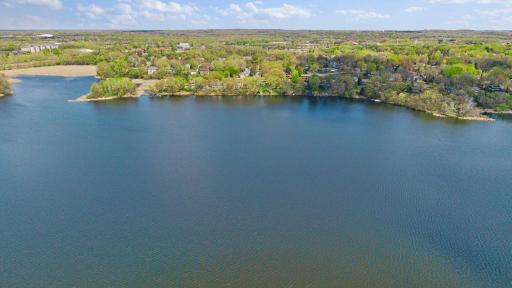 The property also extends 10 feet into the water, allowing for a larger dock, an uncommon and valuable feature. An extraordinary blend of luxury, space, and location, this is lakefront living at its finest in Eden Prairie!