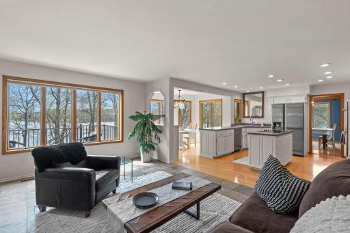 Expansive south-facing windows frame breathtaking lake views throughout the home, effortlessly blending the interior with natural beauty.