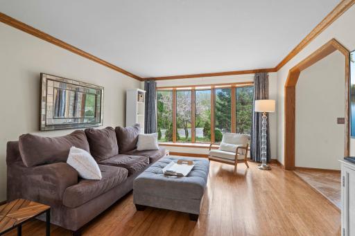 The living room features bay windows and refined wood detailing.